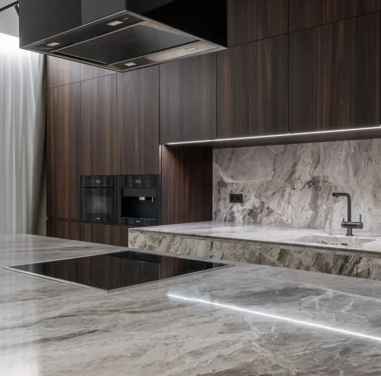 Modern luxury kitchen with natural stone countertops and stone backsplash