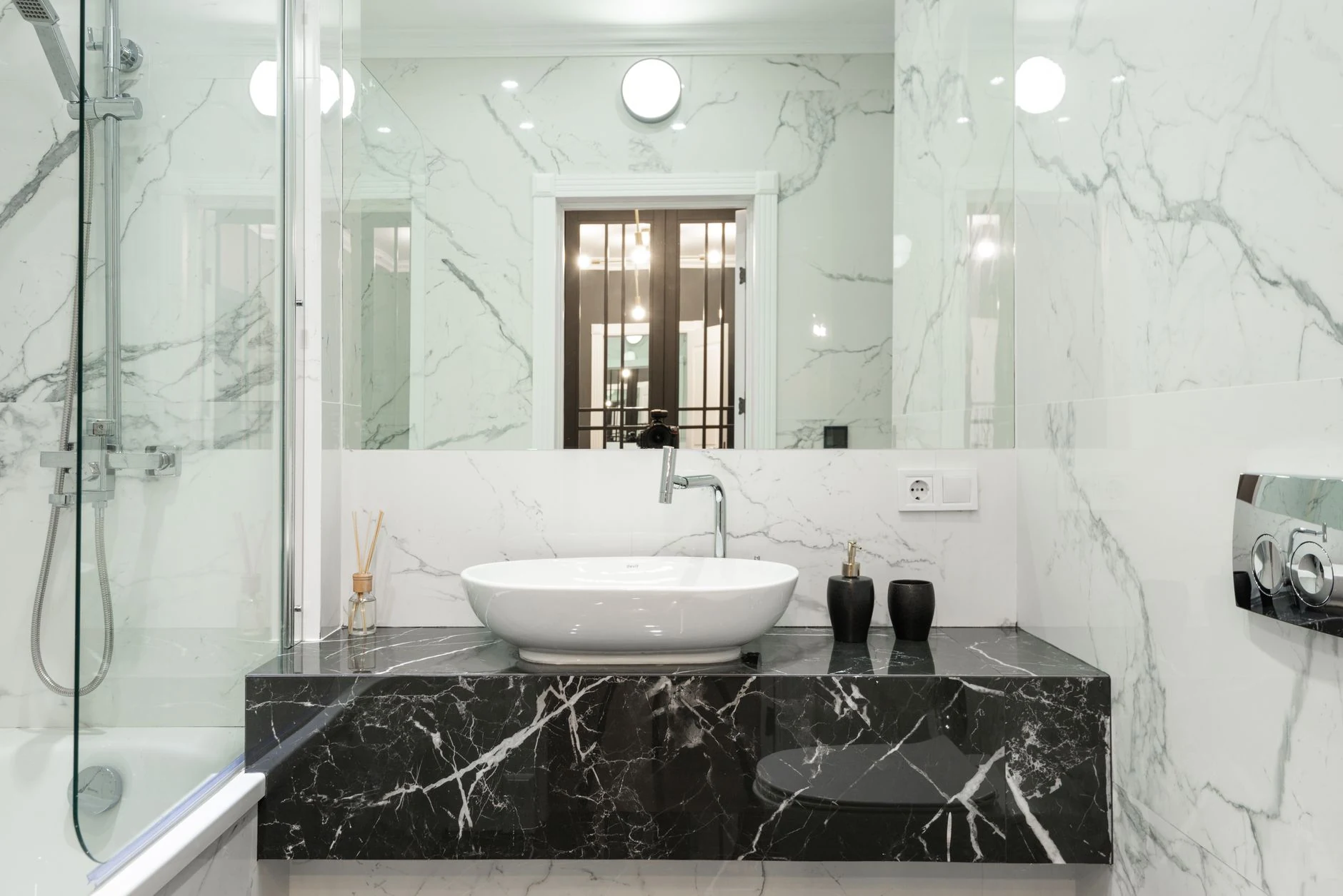 Luxury bathroom vanity with white and black stone surfaces