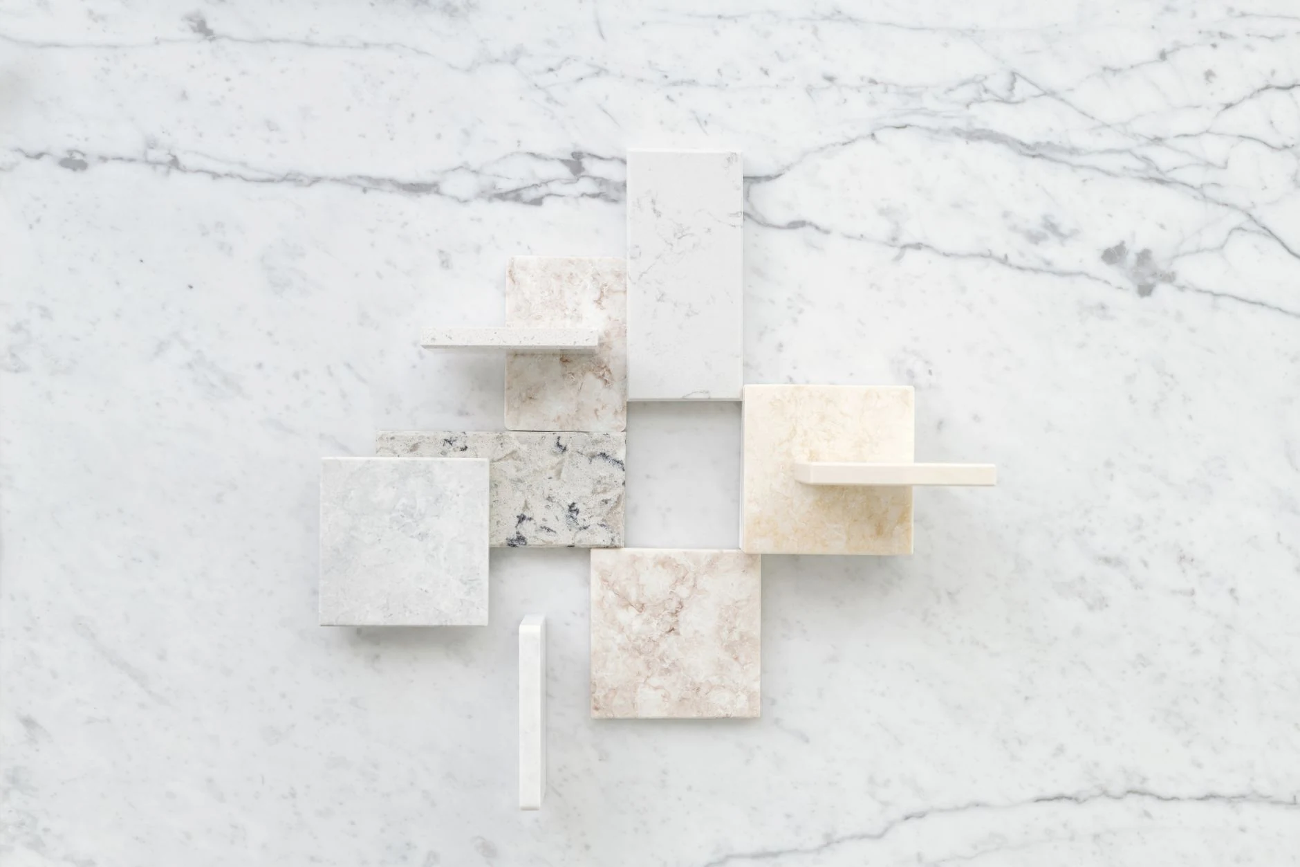 Natural stone samples arranged over a light stone surface